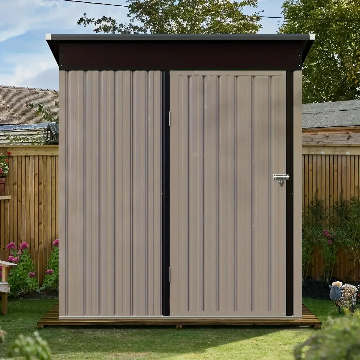 Small 3x5 ft beige metal shed with a slanted roof and a single locking door in a fenced backyard.